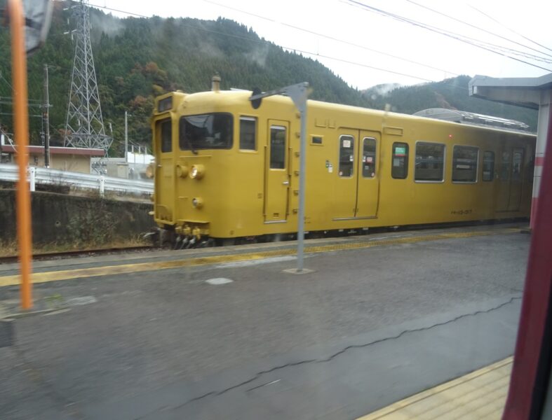 根雨駅に停車中の普通列車とすれ違い